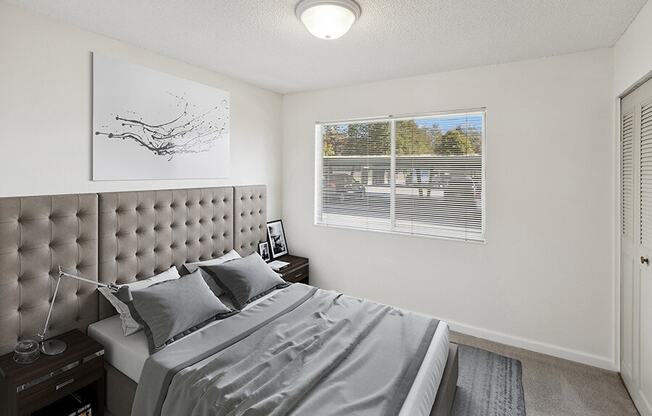 Model Bedroom with Carpet and Closet at Walnut Creek Apartments located in Walnut Creek, CA.