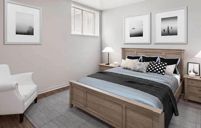 A bedroom with a bed, chair, and three pictures on the wall.