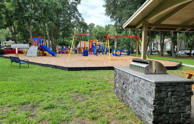 Chelsea Apartments in Gainesville Florida photo of playground and grill area