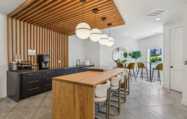 A modern kitchen with a wooden ceiling and a long wooden table.