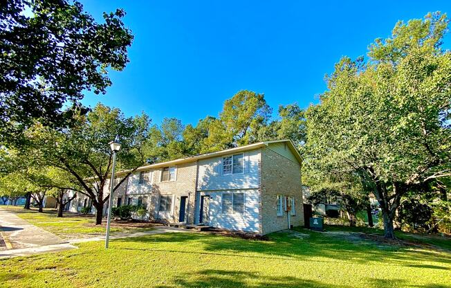 exterior building view with greenery at The Retreat @ St. Andrews Apartments by ICER, Columbia, SC