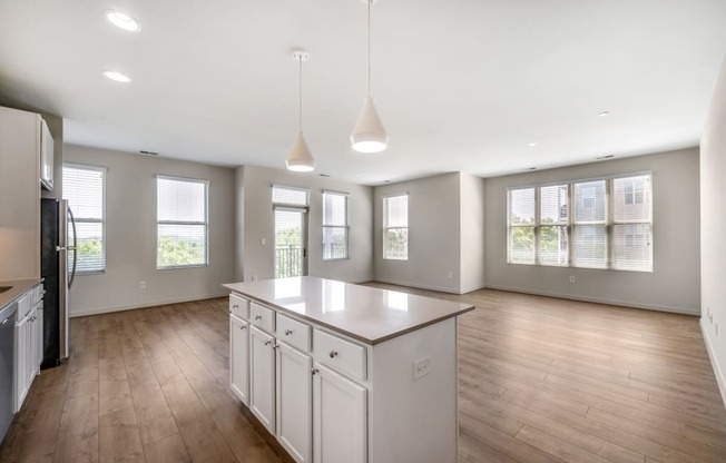 an empty kitchen with an island in the middle of it