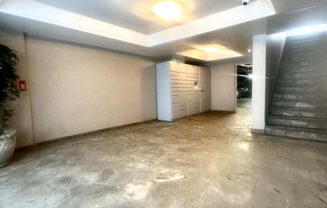 the lobby of a building with a marble floor and a staircase