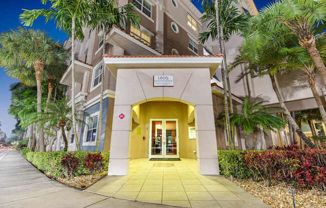 The image shows a building entrance with a yellow door and a sign that reads "1050".