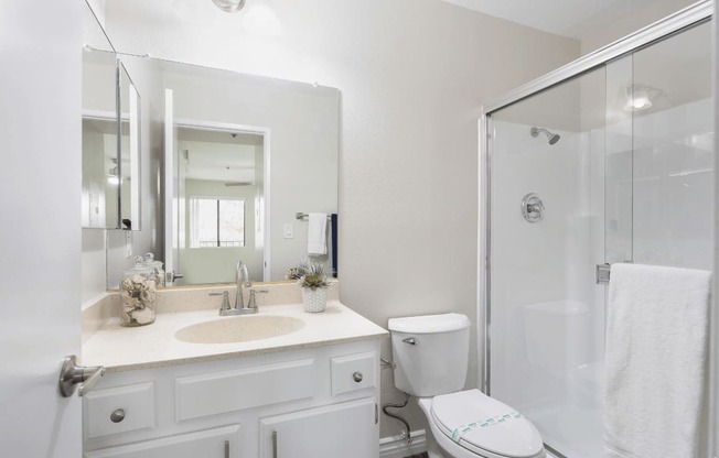 a white bathroom with a shower sink and toilet at Huntington Terrace North Senior, Huntington Beach, 92648