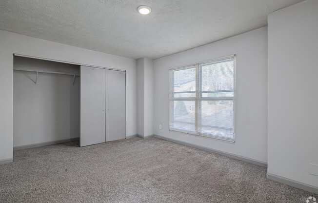 Empty room with a window and a door.