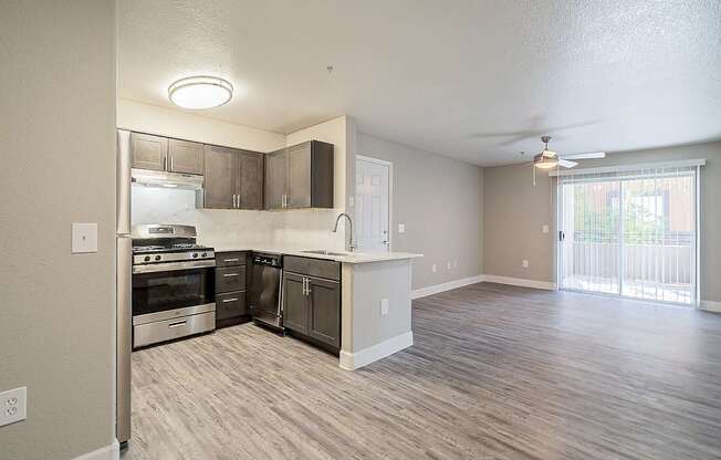 A kitchen with a refrigerator, oven, and sink at Sterling Point Apartment Homes, Arizona, 85042