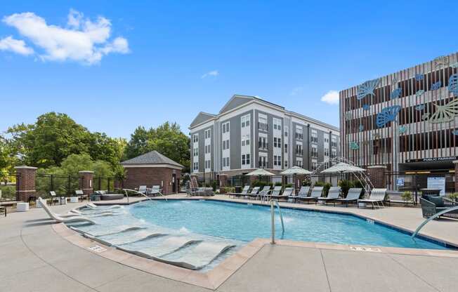 a swimming pool with a building in the background