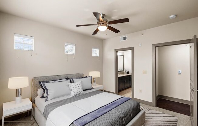 a bedroom with a large bed and a ceiling fan