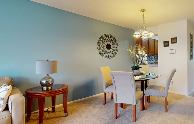 a living room and dining room with a table and chairs