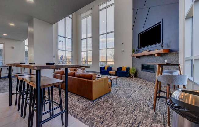 A modern living room with a bar area and a fireplace.