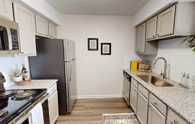 a kitchen with granite counter tops and stainless steel appliances