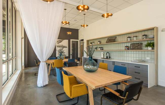 a dining room with a wooden table and yellow chairs