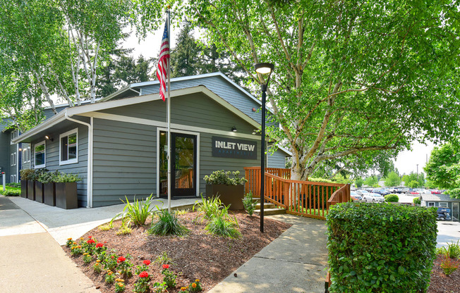 a gray building with an american flag in front of it