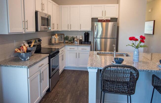 a kitchen with white cabinets and a glass floor