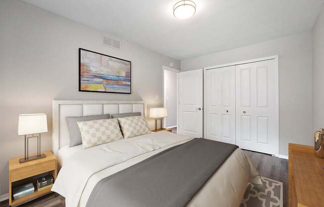 A bedroom with a large bed and a painting above it.