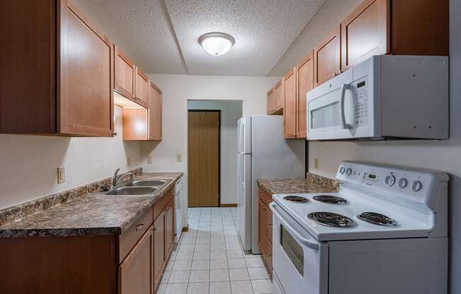 a kitchen with white tile floors and white appliances at France, Fargo, ND 58103