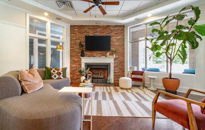 a living room with furniture and a brick fireplace