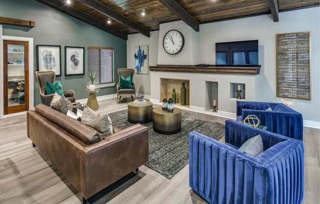 Inviting community lounge with fireplace feature wall, TV nook, and modern seating.
