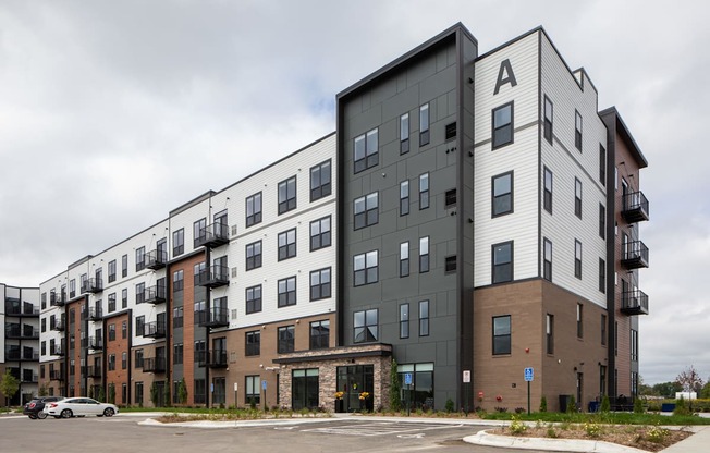 a new apartment building on a city street at The Edison at Maple Grove, Maple Grove