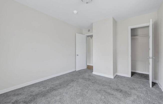A room with grey carpet and white walls at Highland Ridge Apartments, Maryland