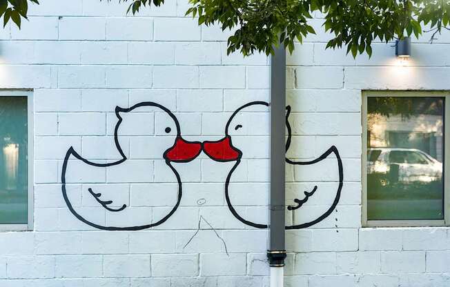 a mural of two birds on the side of a building