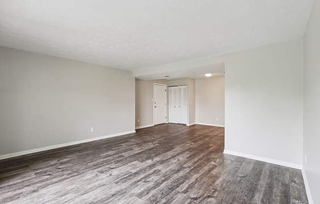 A room with a wooden floor and white walls.