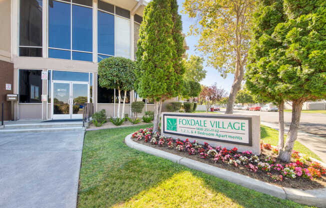 A sign for Foxdale Village Bed and Breakfast is in front of a building.