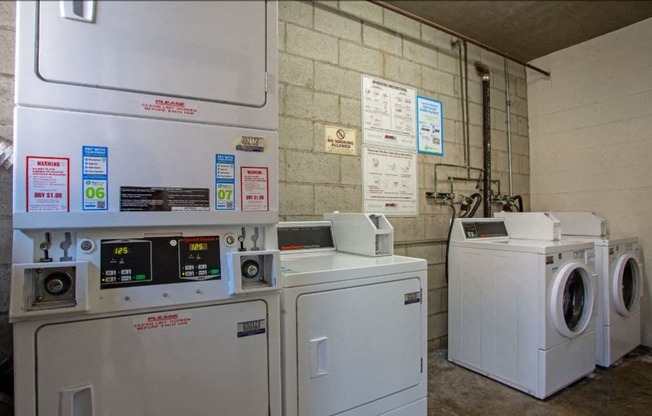 a laundry room with two washing machines and washers