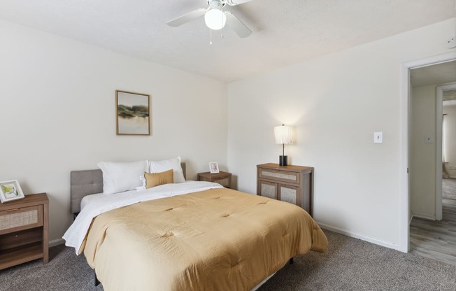 a bedroom with a bed and a ceiling fan