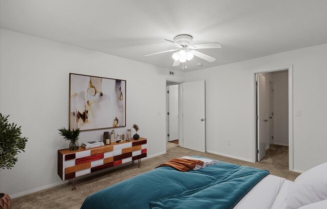 a bedroom with a bed and a ceiling fanat Millcreek Woods Apartments, Olathe, Kansas