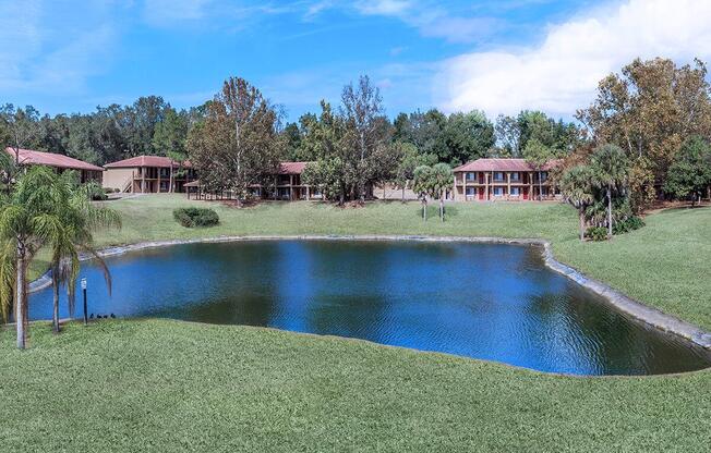 a house with a pool in front of a body of water