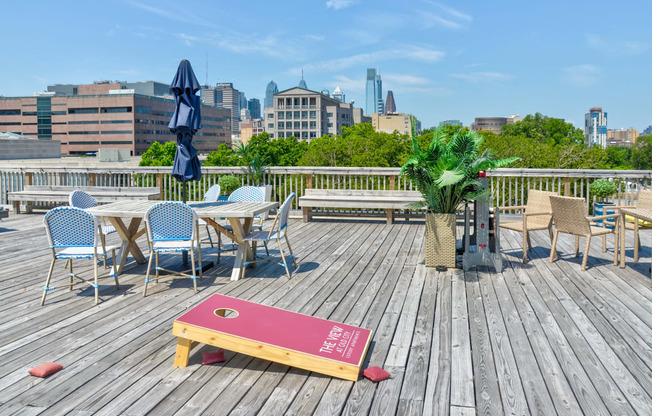 Roof deck with tables and chairs and a view of the city at The View at Old City, Philadelphia