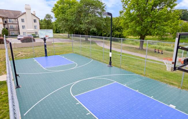 the basketball court at the whispering winds apartments in pearland, txat Millcreek Woods Apartments, Olathe