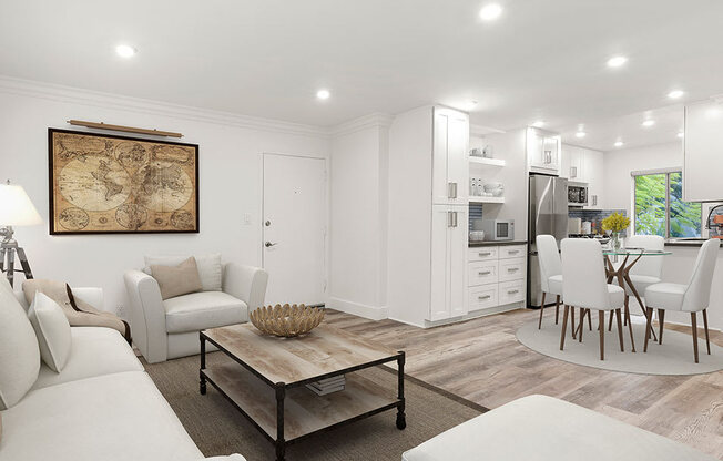 Hardwood floored living room with view of spacious kitchen.