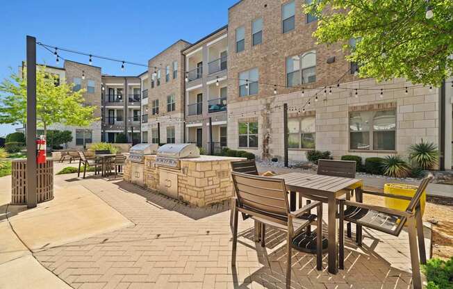 A sunny day at a courtyard with a table and chairs.
