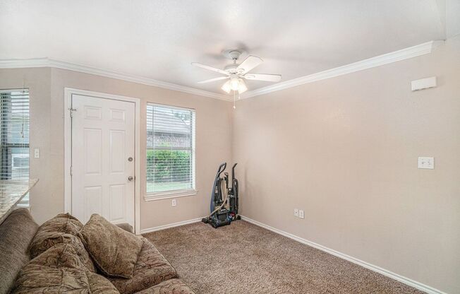 Beautiful two story townhome, crown molding, granite countertops, stained cabinets and carpeting in living area.