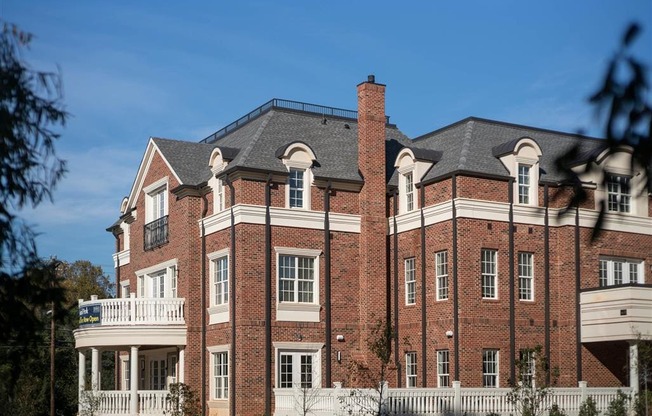 A stately red-brick building with white columns and detailed architecture.