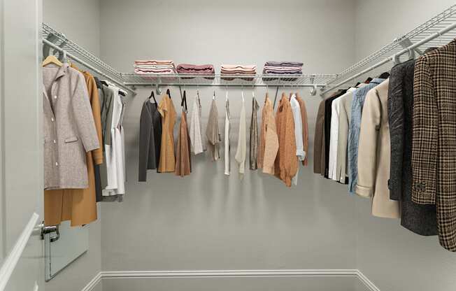 a closet with a rack of clothes hanging in it
