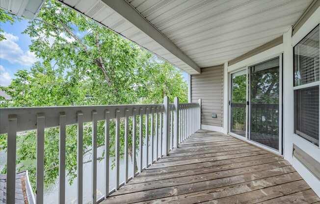 the deck has a view of the trees and the water