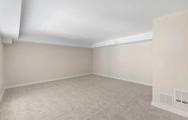 Spacious Living Room with a Plushily Carpeted Floor and Beige Walls at Excalibur Apartment Homes, Bellevue, 98004