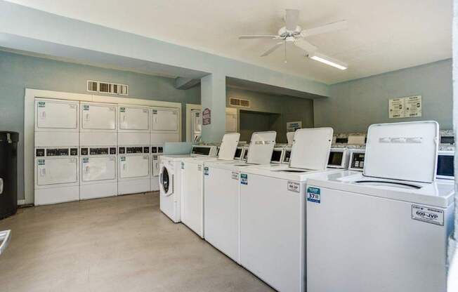 A row of washing machines in a laundromat.