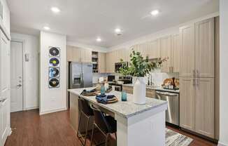 A kitchen with a white island and wooden cabinets.