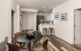 a kitchen and dining room with a table and chairs