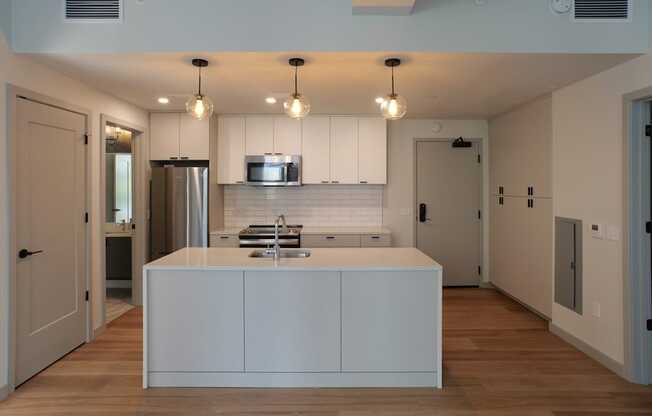 a kitchen with white cabinets and a white counter top in a house at The Commonwealth Building, Pittsburgh, 15222