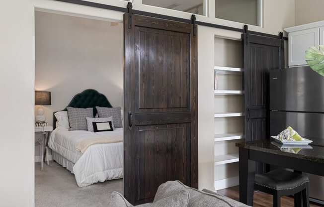 a bedroom with a bed and a sliding barn door at Hayden Lofts, Dublin, Ohio