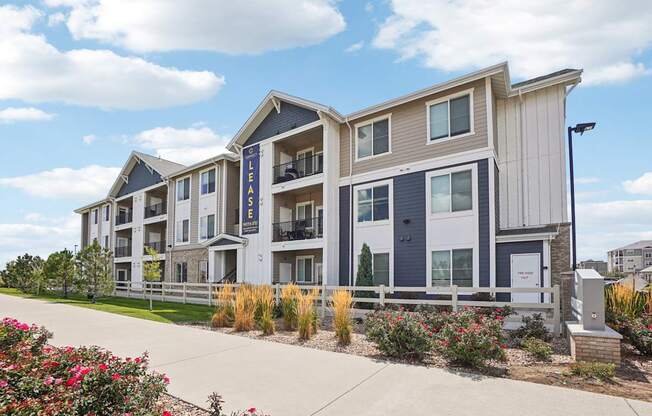 A modern apartment building with the sign  at Connect at First Creek Apartments, Denver, CO, 80249