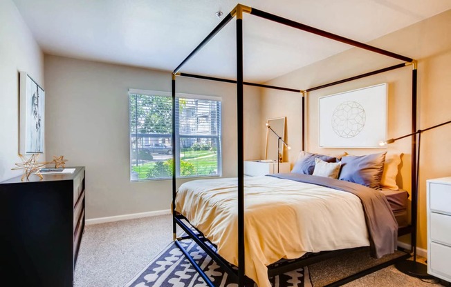 A fully furnished bedroom at Eagles Landing at Church Ranch Apartments