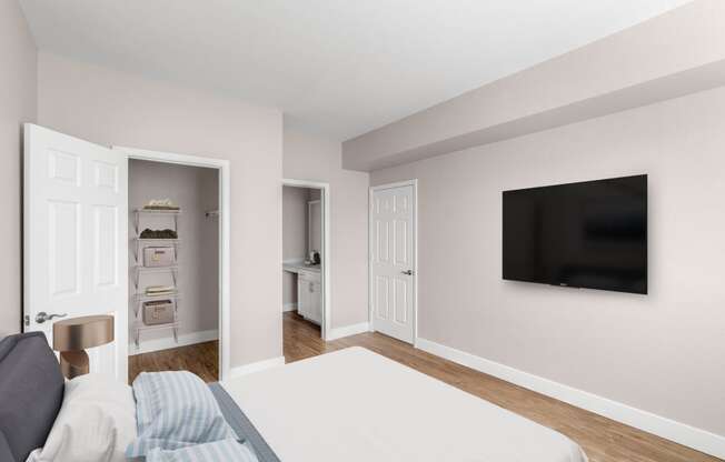 a bedroom with a bed and a tv on the wall at Plum Creek in Castle Rock, CO