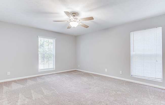 Spacious bedroom with ceiling fan and carpet at Parkside at Sandy Springs Atlanta, GA